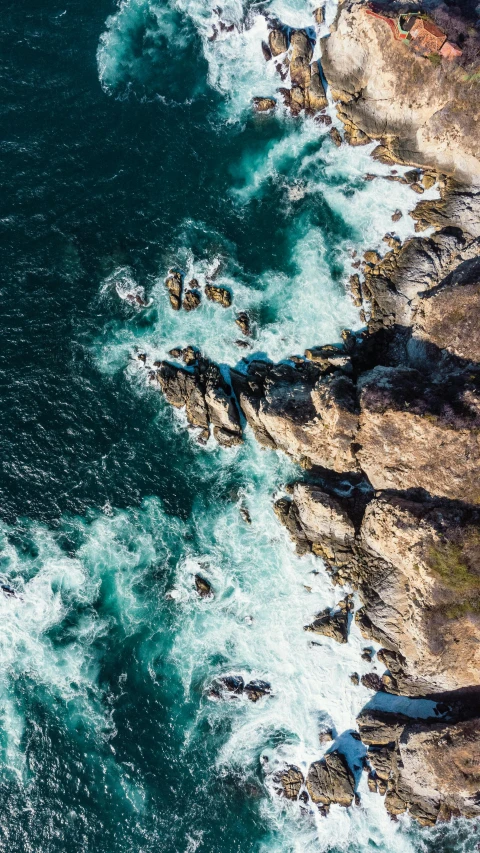 a view of the ocean from a bird's eye view, pexels contest winner, rocky cliffs, thumbnail, slide show, turbulent water