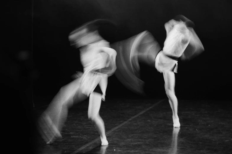 a couple of people that are on a stage, a black and white photo, by Jan Rustem, figuration libre, motion blured movement, saatchi art, female dancer, multiple exposure