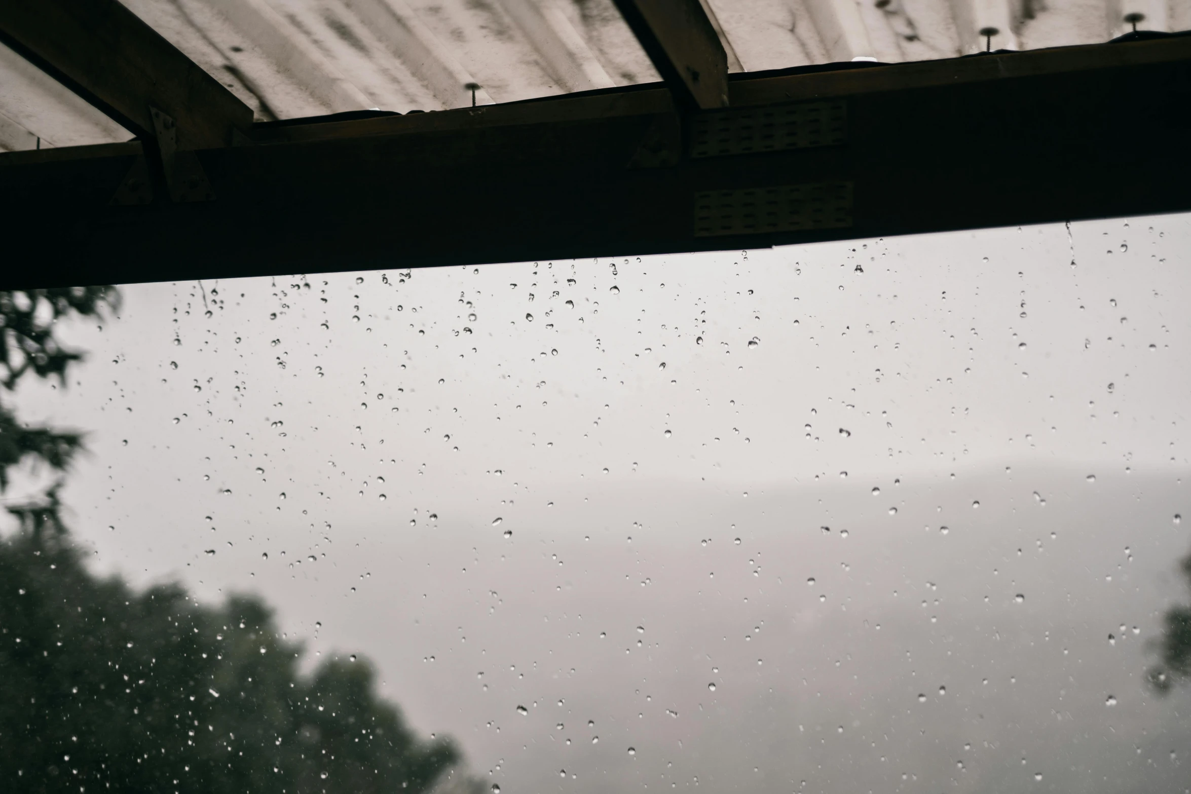 a close up of a window with rain on it, trending on unsplash, shed roof, background image, partially submerged, instagram post
