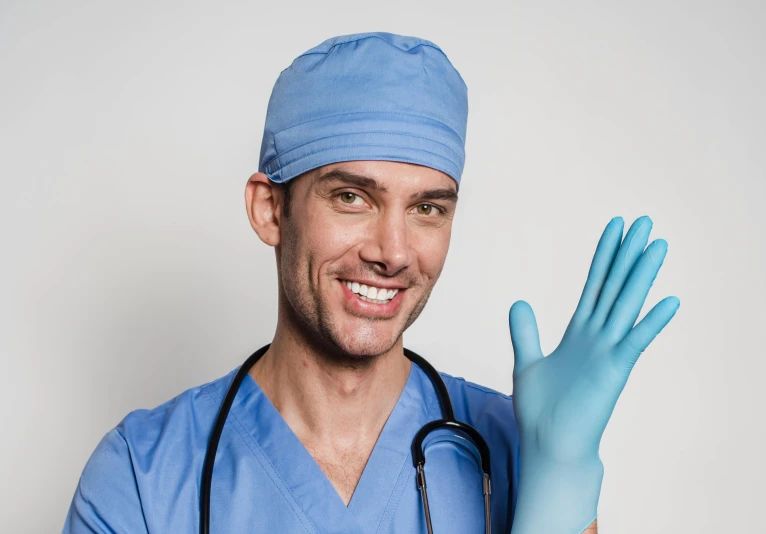 a man wearing a blue scrub suit and blue gloves, a portrait, shutterstock, massurrealism, smileing nright, mignogna, brown, surgical supplies