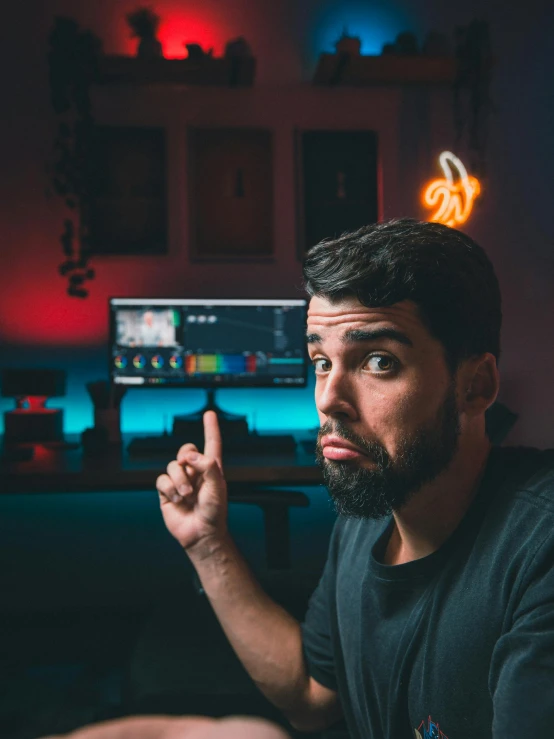 a man sitting on a couch in front of a computer, by Adam Dario Keel, pexels contest winner, video art, giving the middle finger, shot at night with studio lights, discord profile picture, headshot profile picture