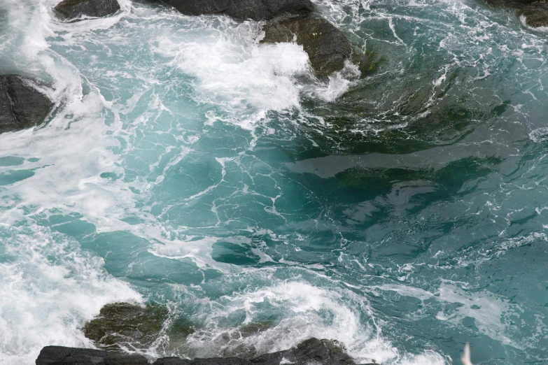 a man riding a surfboard on top of a wave, inspired by Andreas Gursky, pexels contest winner, process art, puddles of turquoise water, cornwall, river rapids, rocky shore