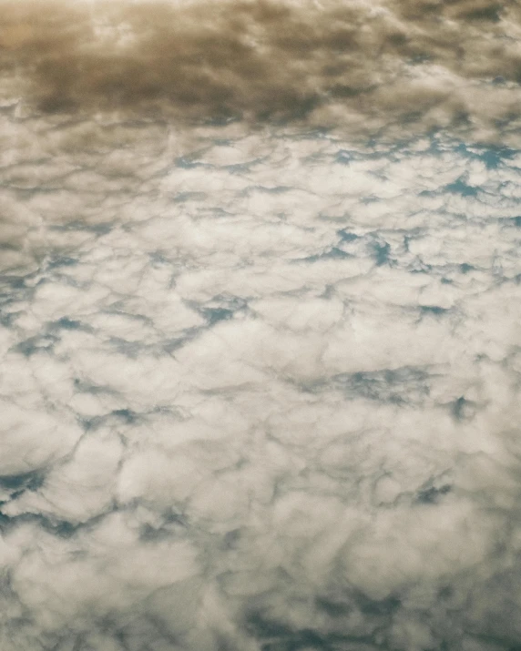 a large jetliner flying through a cloudy sky, an album cover, by Alison Geissler, trending on unsplash, surrealism, close-up from above, cotton clouds, high quality photo, dust clouds | homoerotic