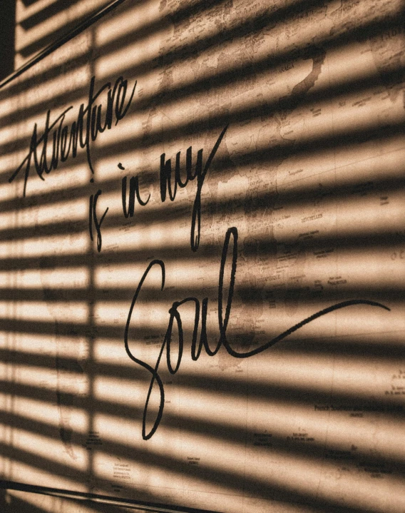 a wall that has some writing on it, an album cover, trending on unsplash, with backdrop of god rays, thumbnail, low quality photo, caligraphy