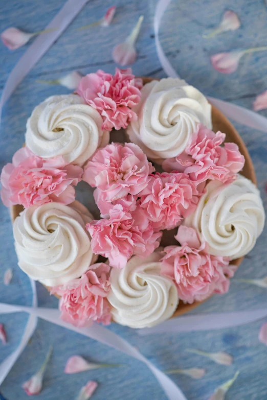 a cupcake with white frosting and pink flowers, renaissance, close-up from above, liberty curls, award - winning details, carnation