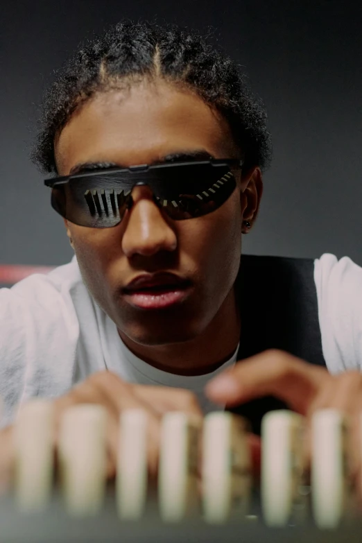 a man in sunglasses playing a game of dominos, an album cover, by Washington Allston, unsplash, visual art, ashteroth, still from a music video, linus sebastian, still frame