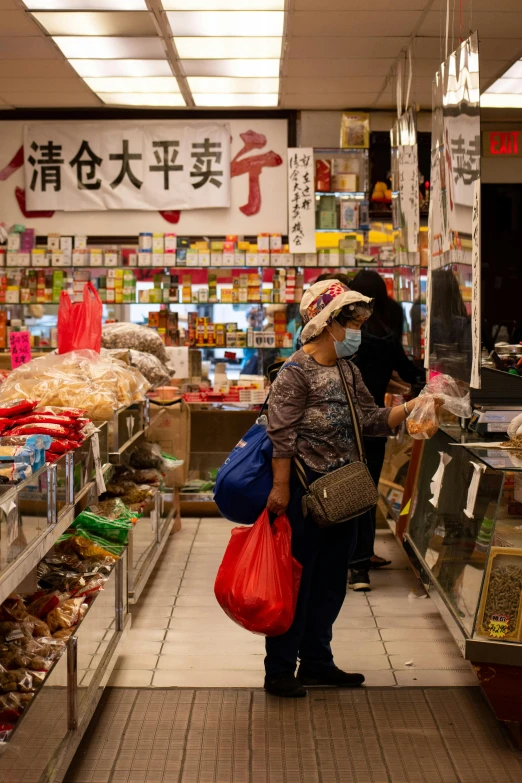 a couple of people that are standing in a store, chinatown, shopping groceries, taken in 2 0 2 0, rectangle