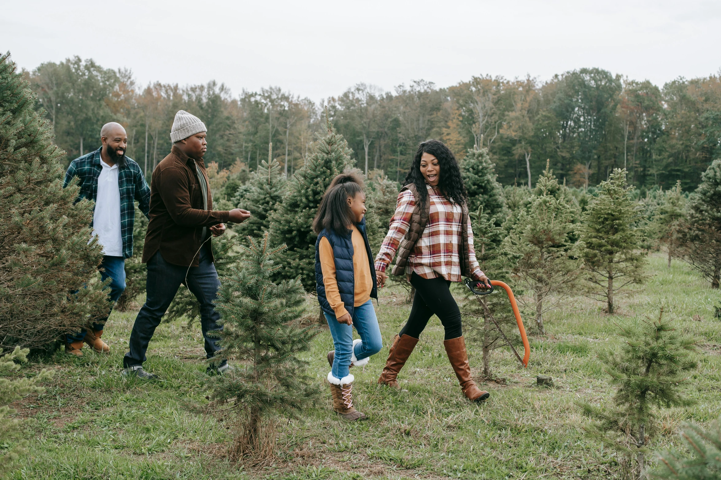 a family walking through a christmas tree farm, pexels, folk art, tessa thompson, 1 6 x 1 6, press photo, dwell