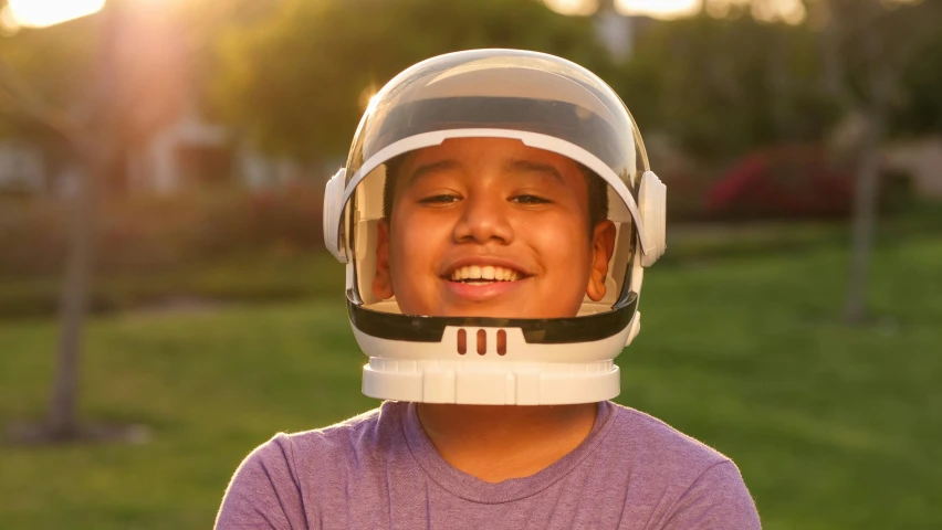 a close up of a person wearing a helmet, by Dan Luvisi, incoherents, happy kid, spacehip lands, asian human, promo image