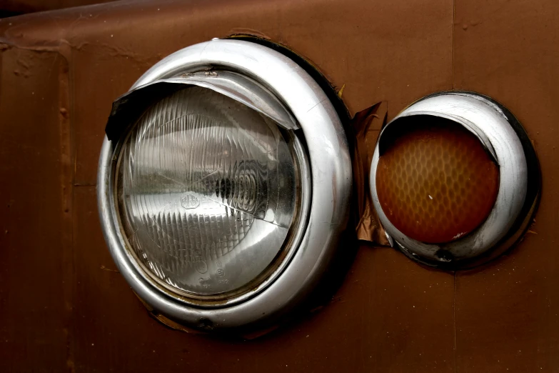 a close up of a light on the side of a truck, by Sven Erixson, pexels contest winner, photorealism, portholes, brown, chrome mask, headlights