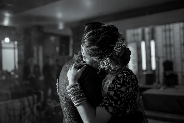 a black and white photo of a woman hugging a man, by Max Dauthendey, pexels contest winner, hurufiyya, indian, ornately dressed, making of, stylized