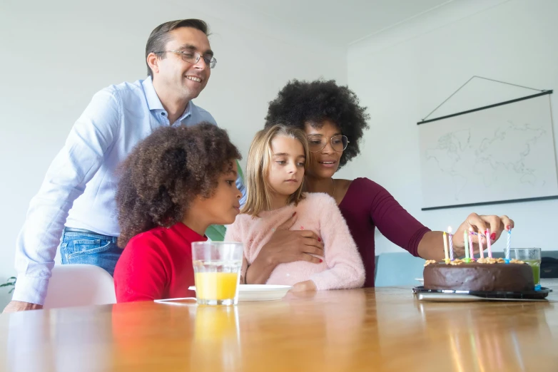 a group of people standing around a table with a cake, family friendly, iq 4, brown, thumbnail