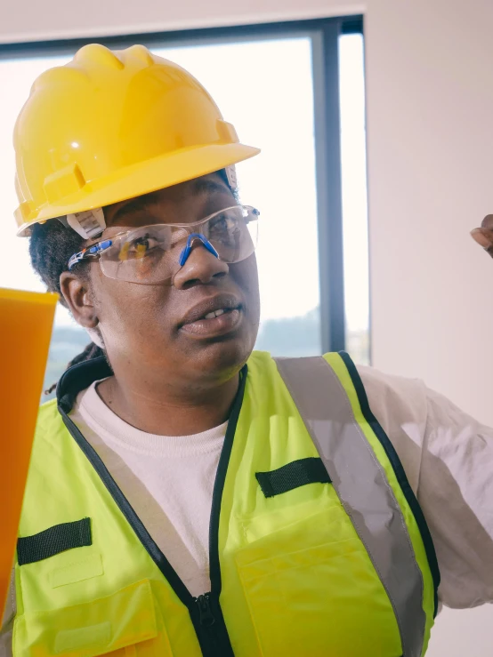 a woman wearing a hard hat and safety glasses, by Arabella Rankin, trending on pexels, lesbians, still frame, maria borges, official screenshot