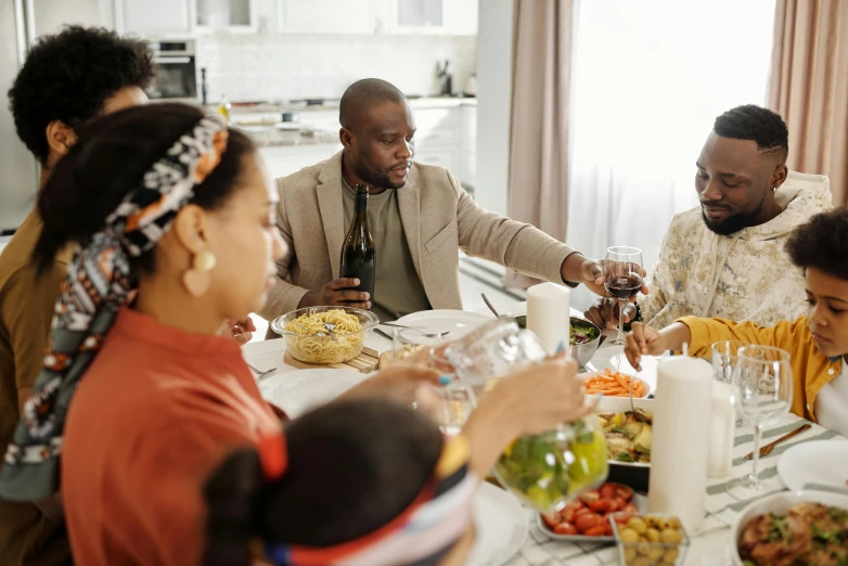 a group of people sitting around a dinner table, black people, on a table, profile image, fan favorite