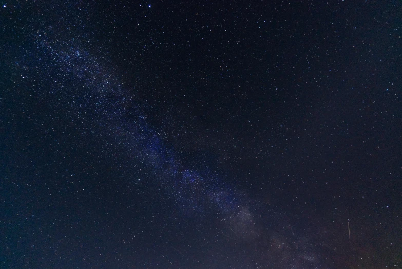 a group of people standing on top of a beach under a night sky, zoomed in, the milk way, rectangle, close - up photograph