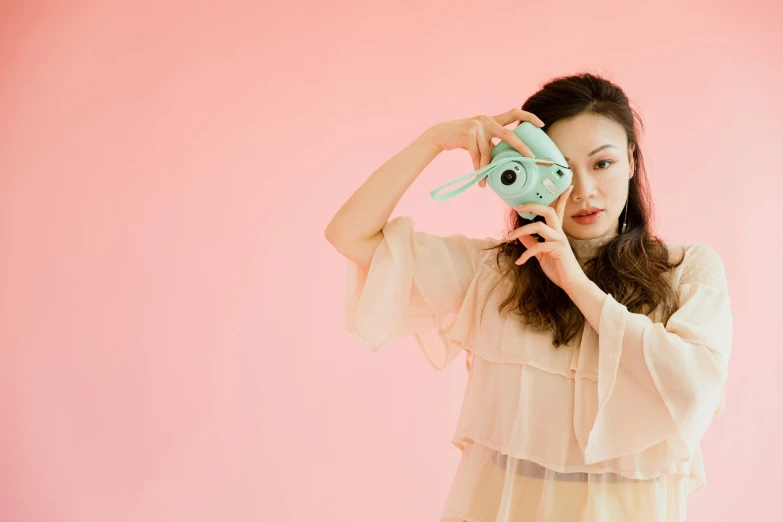 a woman taking a picture with a camera, unsplash, pop art, pastel green, jellycat, jamie chung, kiko mizuhara