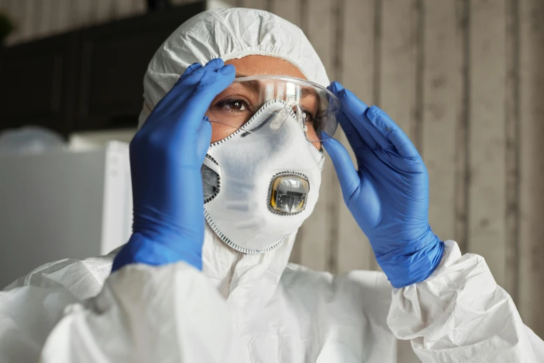 a close up of a person wearing a mask and gloves, a portrait, shutterstock, plasticien, looking in front, avatar image, maintenance photo, clean medical environment