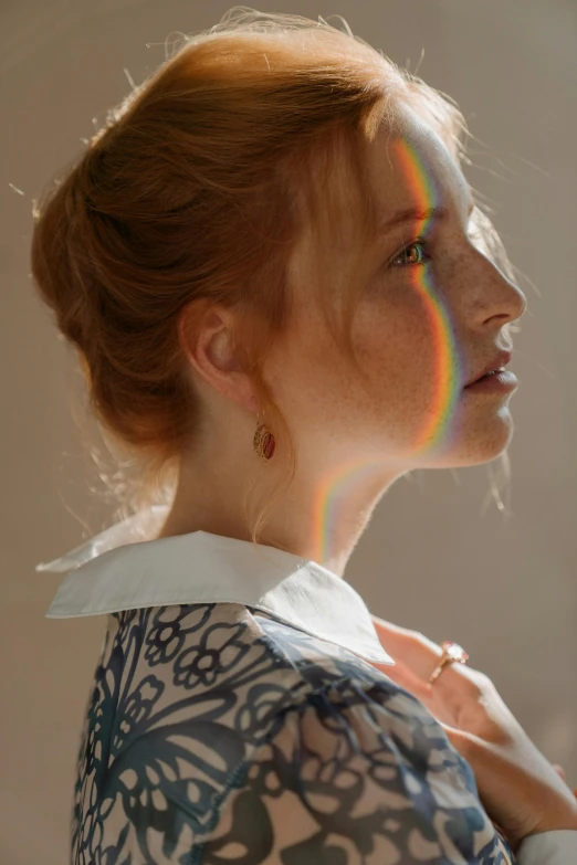 a woman that is standing in front of a mirror, inspired by Anna Füssli, trending on pexels, light and space, rainbow accents, ( redhead, sun lighting, angle profile portrait