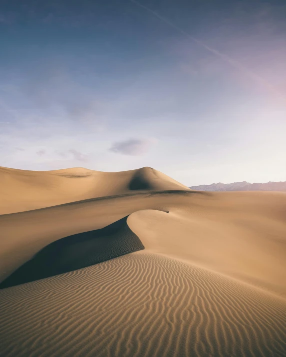 a large sand dune in the middle of a desert, unsplash contest winner, many smooth curves, murky dusty deep, light tan, an expansive grassy plain