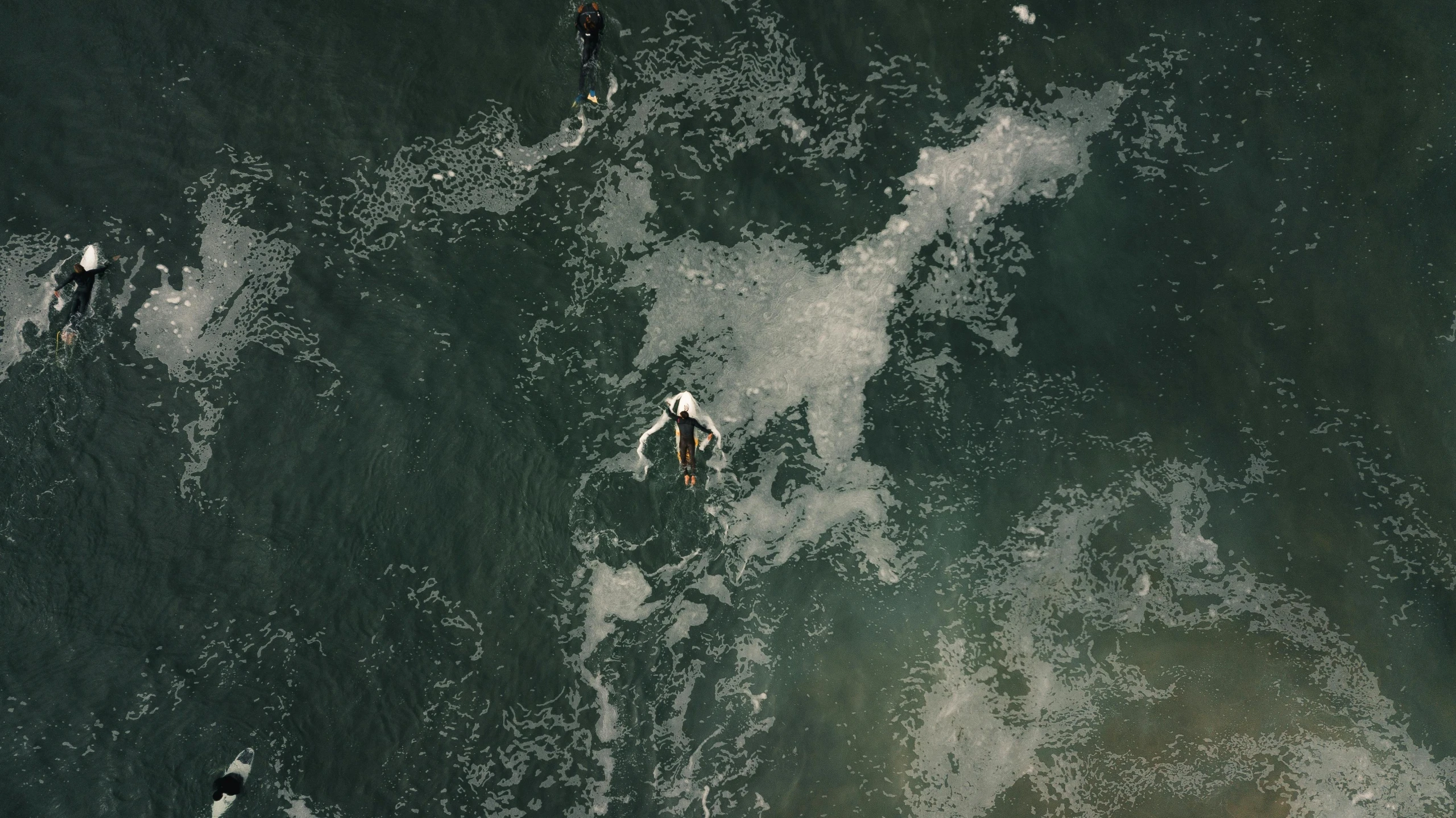 a group of people riding surfboards on top of a wave, an album cover, by Elsa Bleda, pexels contest winner, figuration libre, birds - eye view, polluted, dark green water, ignant