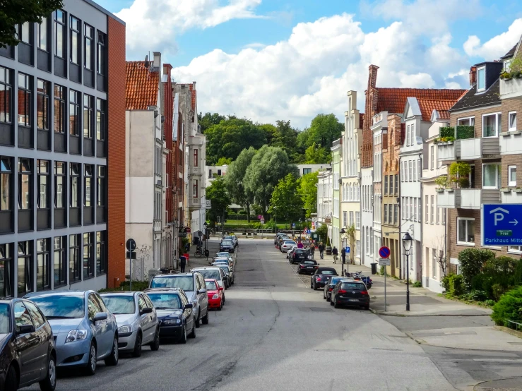 a street lined with parked cars next to tall buildings, by Jan Tengnagel, pexels contest winner, renaissance, white buildings with red roofs, detmold, scandinavian style, square