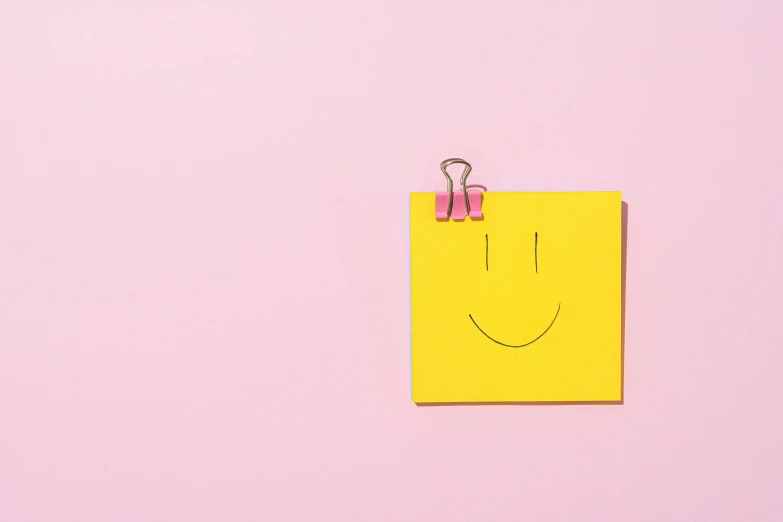 a piece of paper with a smiley face drawn on it, by Nicolette Macnamara, trending on pexels, postminimalism, pink skin, square face, yellow, positive