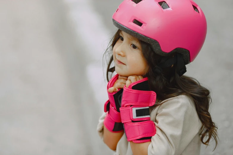 a little girl wearing a pink helmet and gloves, pexels contest winner, instagram post, thumbnail, elbow pads, asian girl