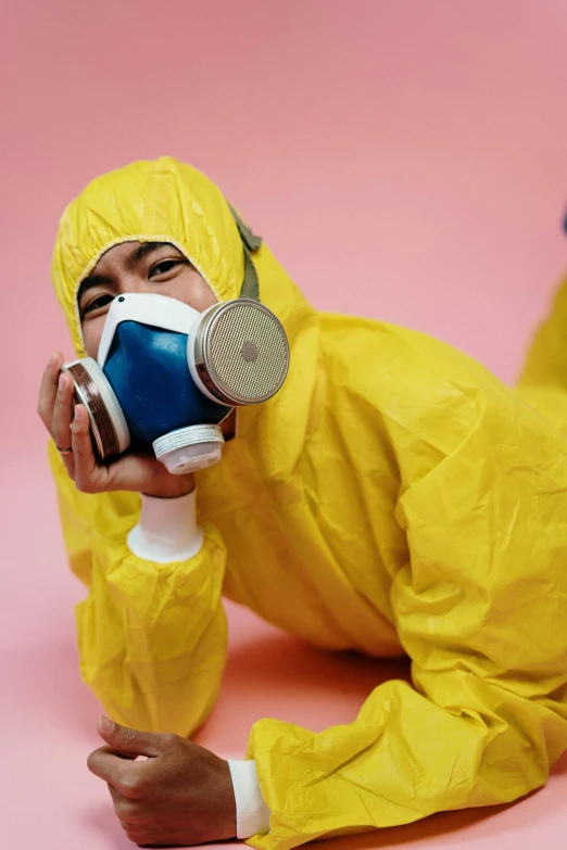 a man in a yellow hazmat suit laying on the ground, pexels contest winner, photograph of a techwear woman, clean room, upset, plain background