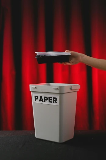 a person throwing a paper into a trash can, an album cover, by Julia Pishtar, pexels contest winner, stop motion, 15081959 21121991 01012000 4k, theater, hidden message