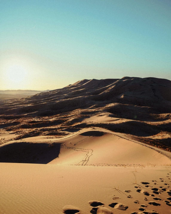 the sun is setting over the sand dunes, an album cover, trending on unsplash, les nabis, moroccan, craters, winter, light tan