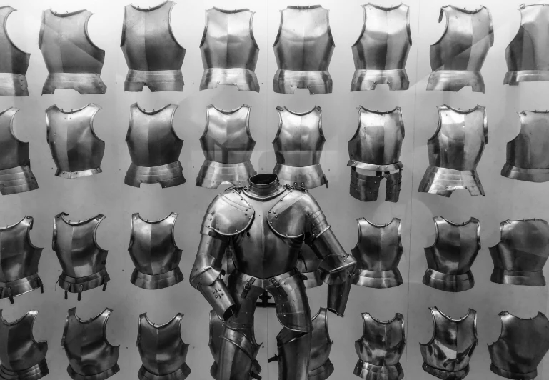 a black and white photo of armor on display, by Adam Marczyński, unsplash, made of metal, [ metal ], chrome outfit, metal shaded