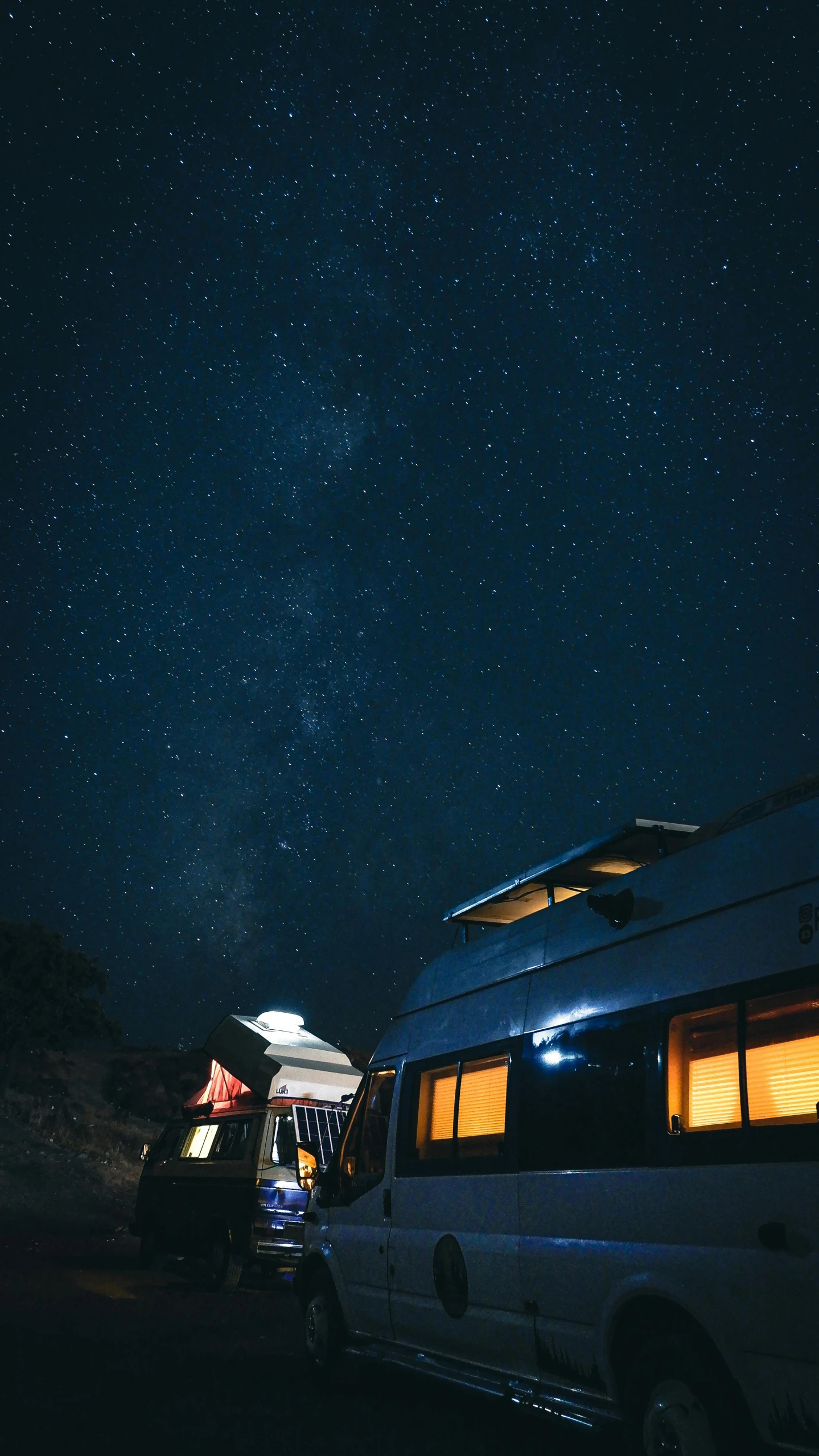 a camper van parked on the side of a road at night, by Jessie Algie, unsplash contest winner, light and space, star roof, exterior view, research outpost, feeds on the entire cosmos