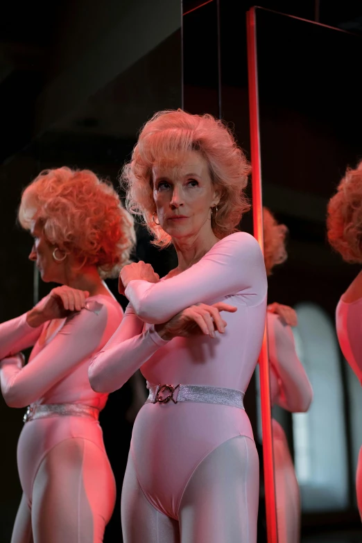 a group of women standing next to each other, a hologram, inspired by Nan Goldin, trending on reddit, kylie minogue as barbarella, older woman, [ theatrical ], wearing a light - pink suit
