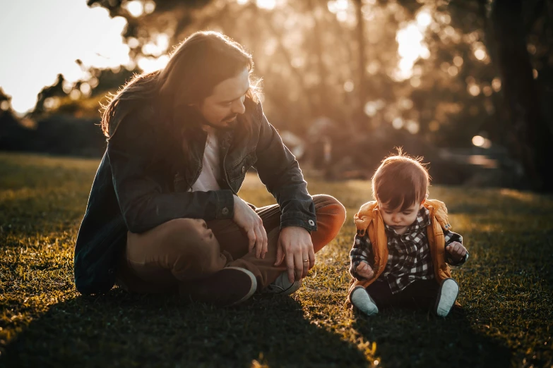 a woman and a child sitting in the grass, pexels contest winner, father with child, sydney park, avatar image, fashionable