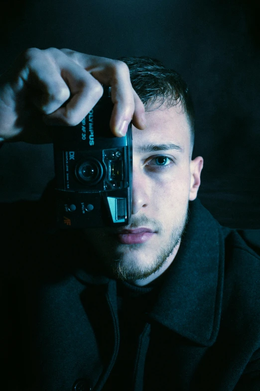 a man taking a picture with a camera, by Adam Marczyński, pexels contest winner, photorealism, portrait of a cyberpunk man, harsh flash photo, rectangle, portrait of a sharp eyed