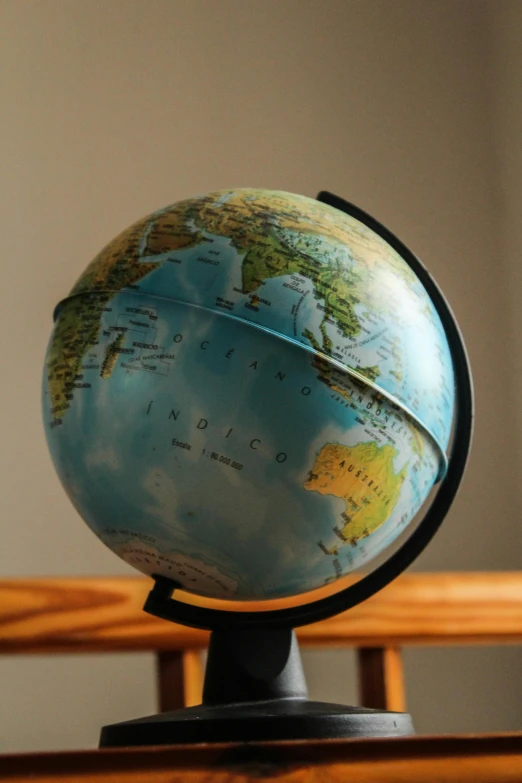 a globe sitting on top of a wooden table