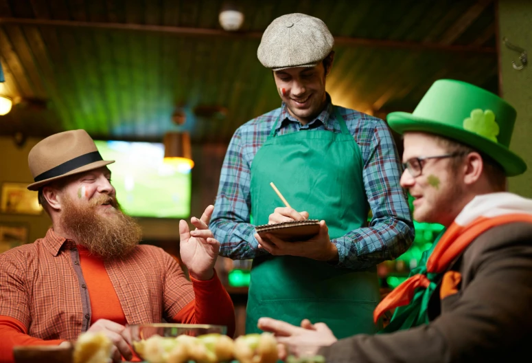 a group of men sitting around a table with food, irish, green and orange theme, daily specials, square