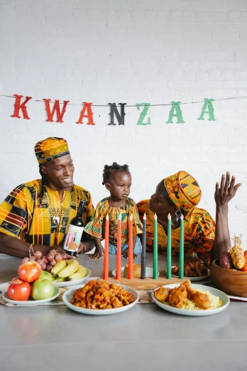 a group of people sitting around a table with food, an album cover, by Ingrida Kadaka, pexels contest winner, wearing festive clothing, portrait of family of three, african, 2 5 6 x 2 5 6 pixels