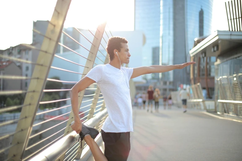 a man standing on a bridge holding a skateboard, pexels contest winner, happening, wearing fitness gear, avatar image, pointè pose, city morning