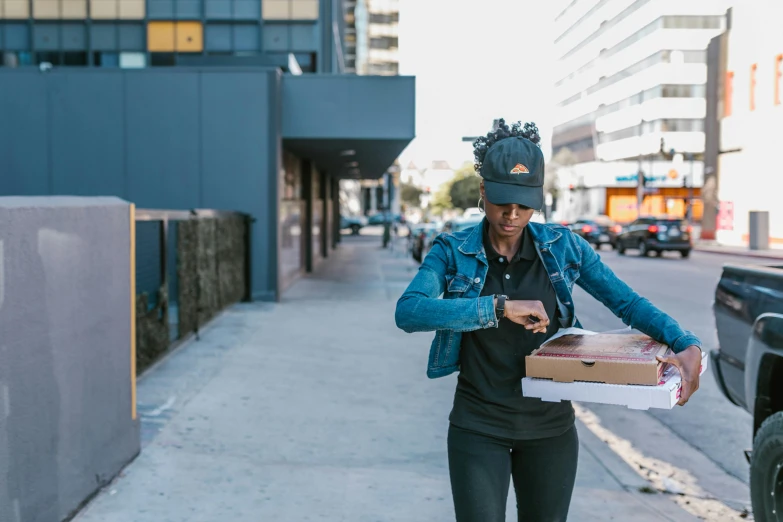 a woman walking down a sidewalk with a box of pizza, a portrait, unsplash, sza, los angeles ca, qiyana, offering a plate of food