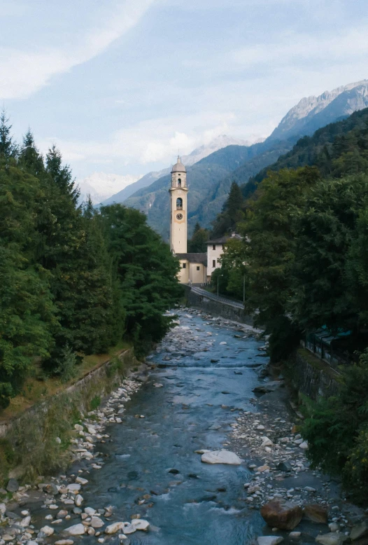 a river running through a lush green forest filled with trees, an album cover, inspired by Giuseppe Tominz, pexels contest winner, alpine architecture, running through italian town, church, alp