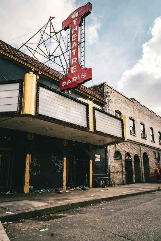 a theater marquee sitting on the side of a road, a photo, trending on unsplash, art nouveau, ornate city ruins, parties, chicago, jc park
