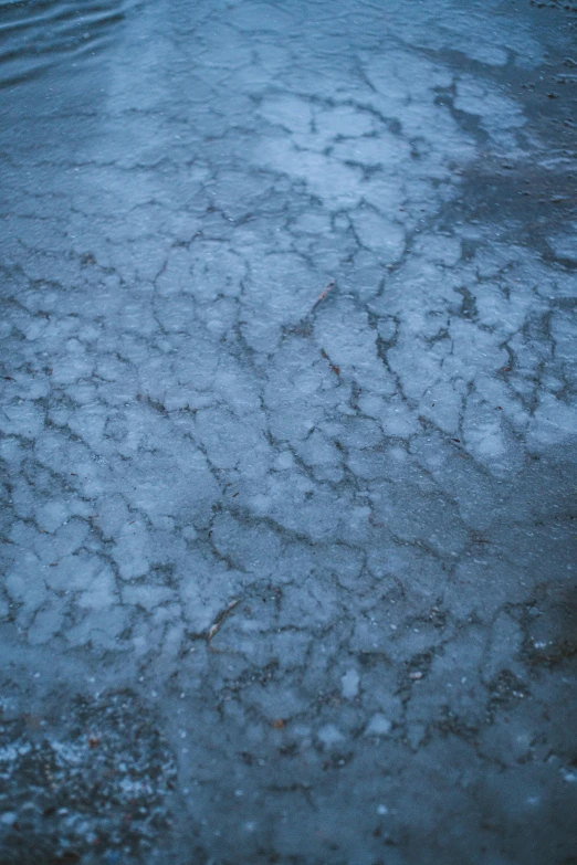 a red fire hydrant sitting in the middle of a lake, inspired by Elsa Bleda, trending on unsplash, land art, frosted texture, blue gray, large cracks, sidewalk