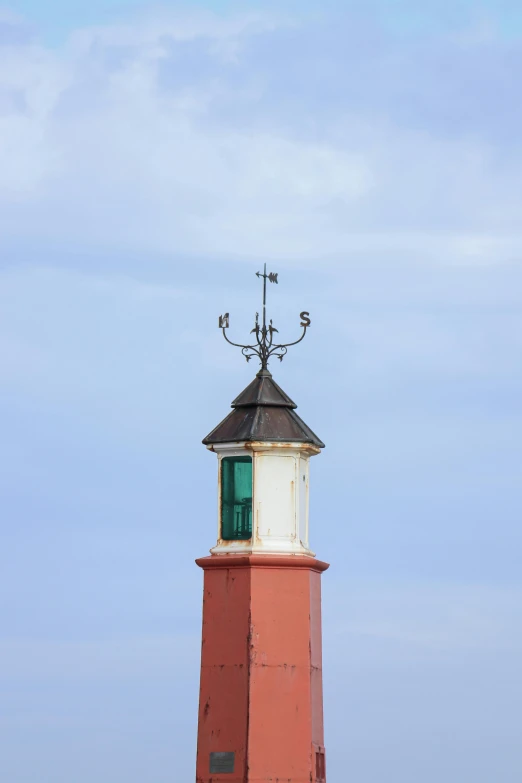 a red and white lighthouse sitting on top of a sandy beach, unsplash, minimalism, square, orange roof, green, clock