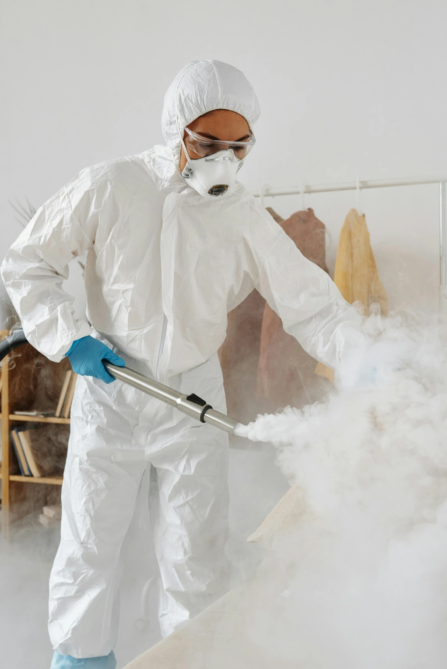 a man in a hazmat suit spraying something with a hose, pexels, process art, smoke filled room, wearing lab coat and a blouse, avatar image, home