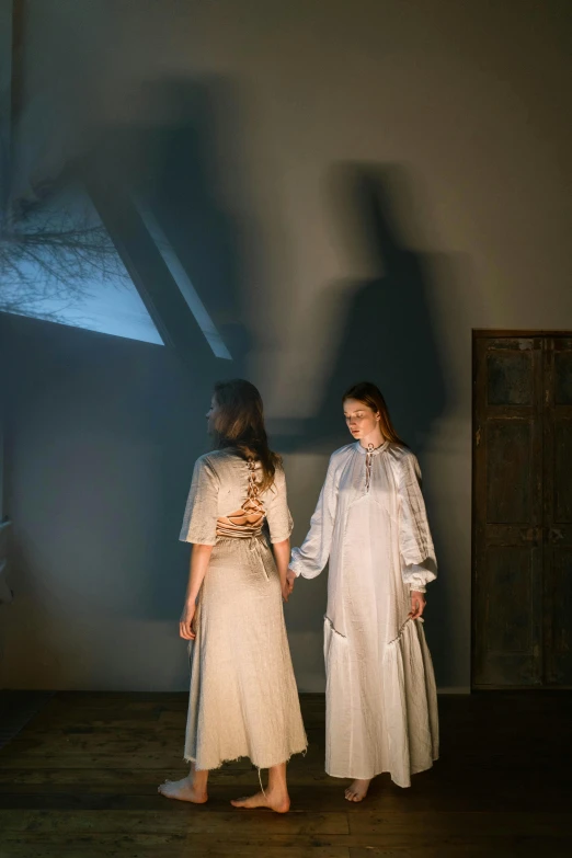 a couple of women standing next to each other, inspired by Pietro Longhi, unsplash, neo-romanticism, projection design installation, southern gothic scene, morning lighting, [ theatrical ]