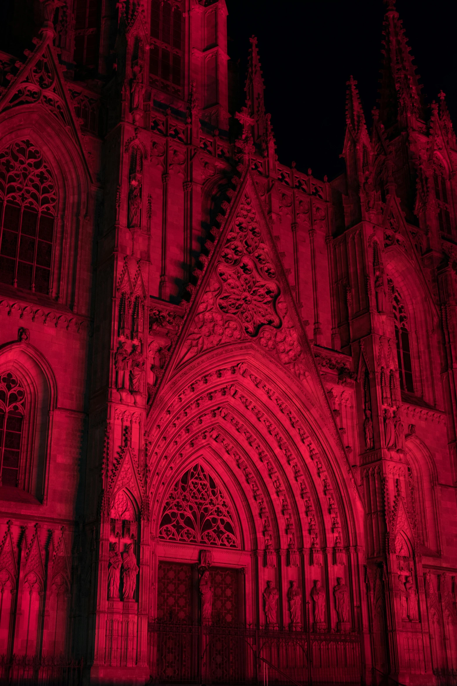 a large cathedral lit up with red lights, gothic art, rose pink lighting, spooky lighting, shades of aerochrome gold, red accents