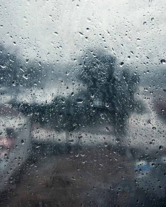 a close up of a window with rain on it, an album cover, trending on unsplash, hurufiyya, view from a news truck, ilustration, low quality photo, battered