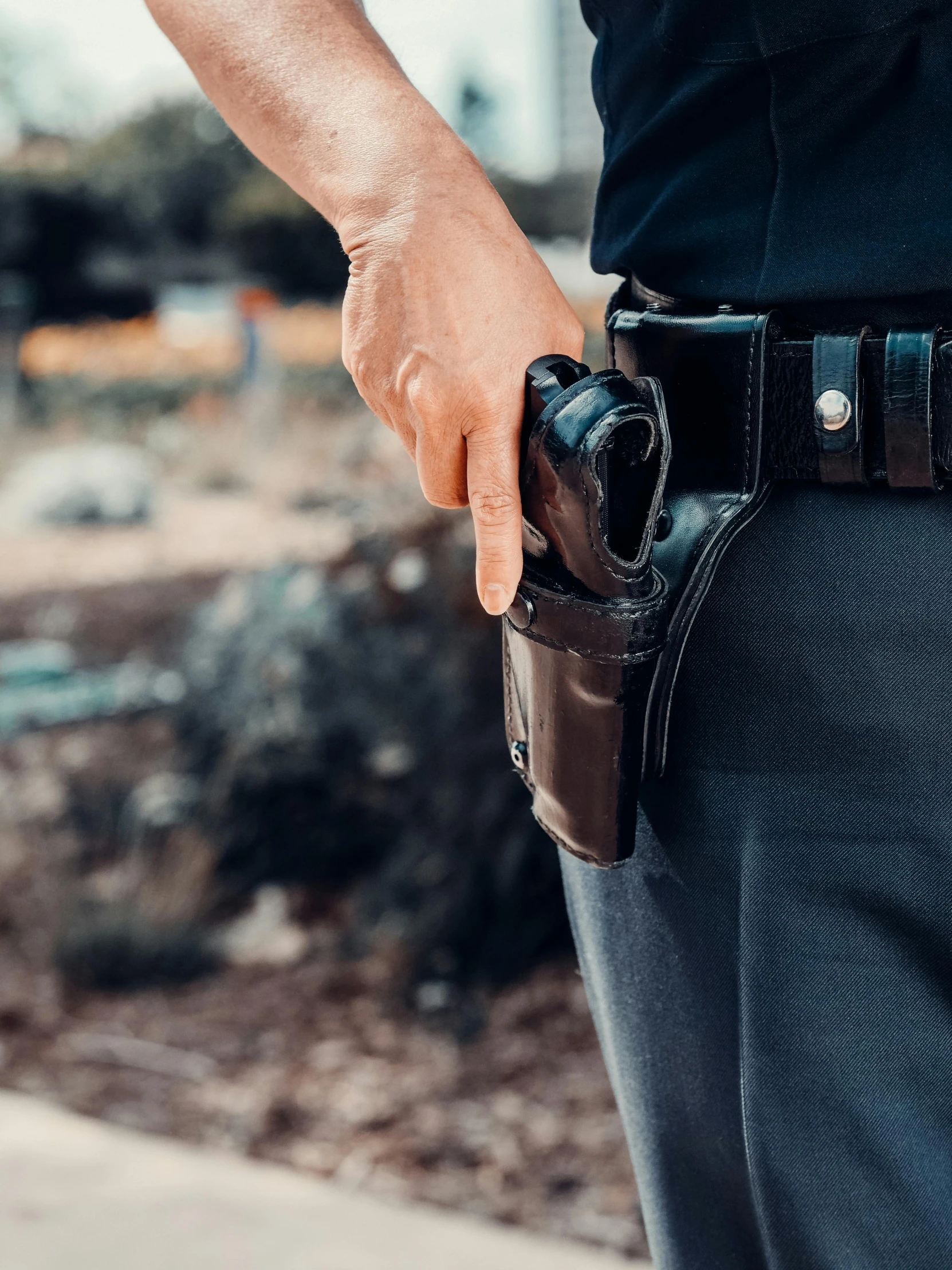 a police officer holding a gun in his right hand, unsplash, renaissance, tool belt, splash image, multiple stories, full frame image