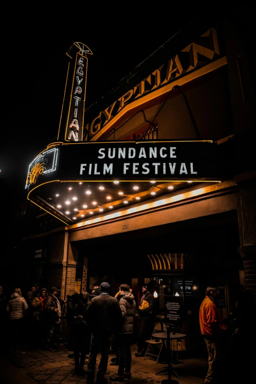 a crowd of people standing outside of a movie theater, by Ryan Pancoast, trending on unsplash, renaissance, summer festival night, square, ( ( theatrical ) ), sun